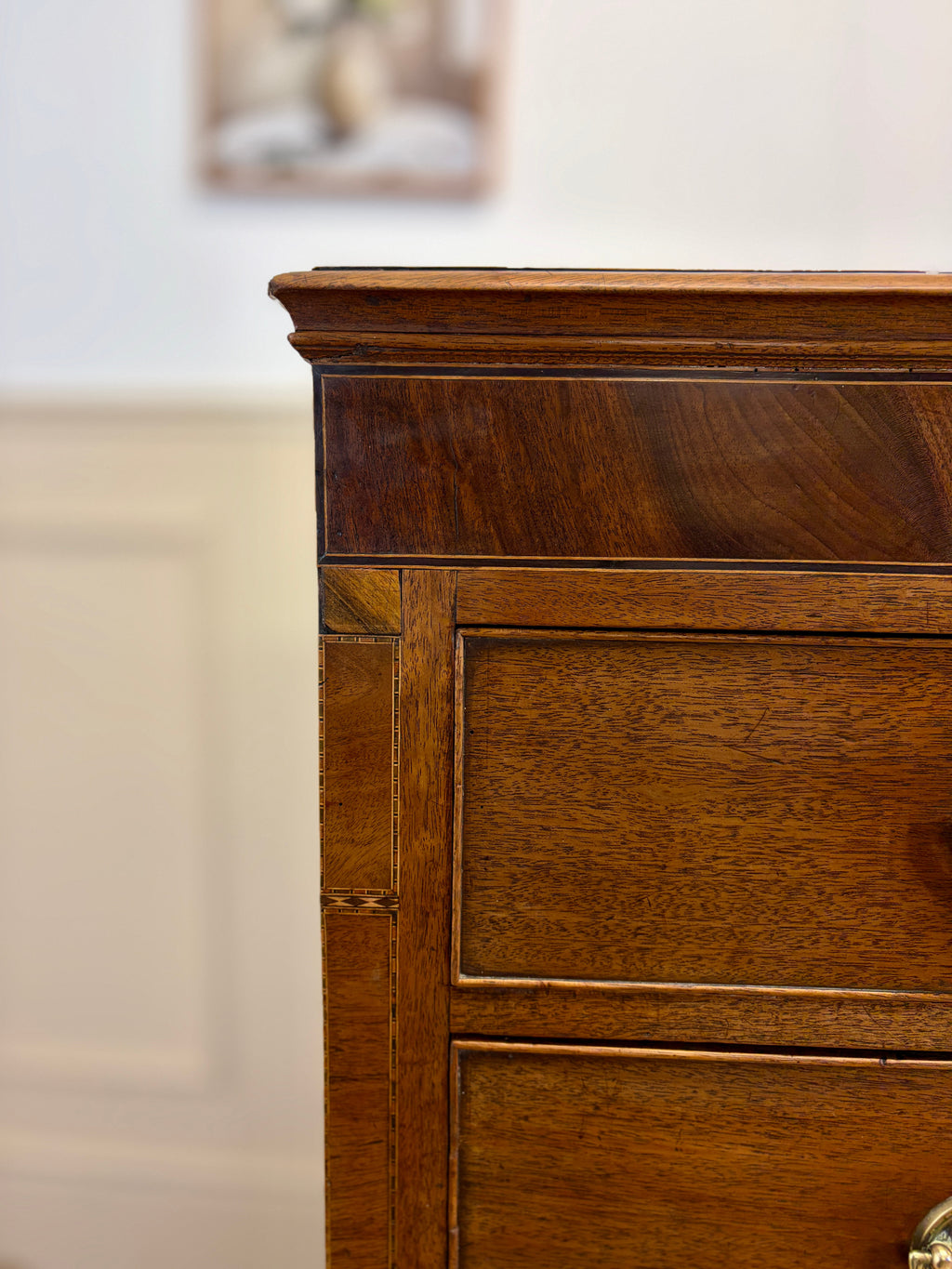 Close-up of a wooden dresser with a blurred background