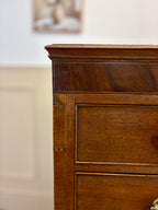 Close-up of a wooden dresser with a blurred background