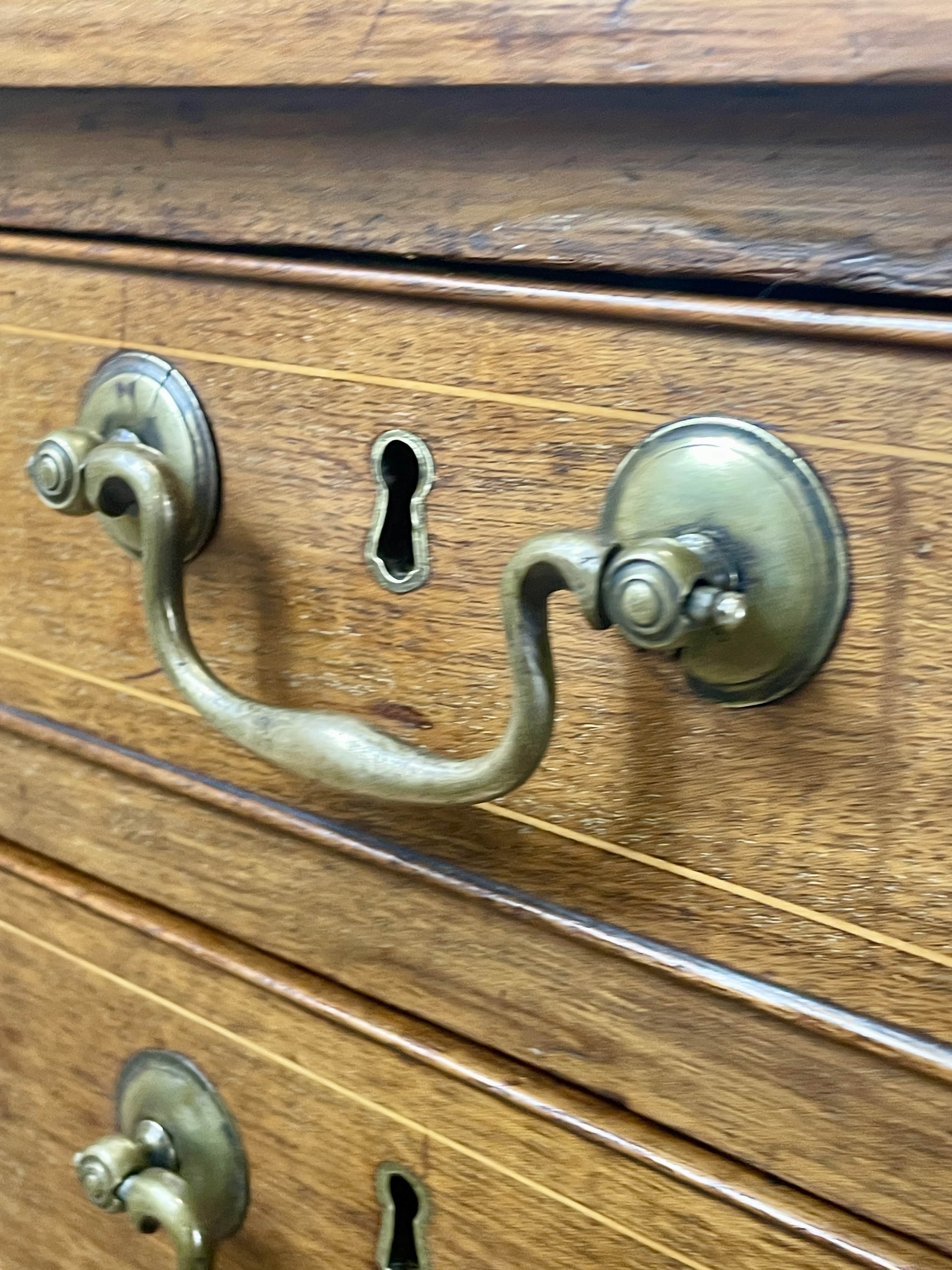Wooden drawer with brass handles and keyholes
