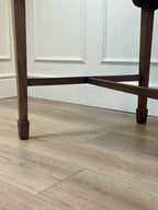 Wooden floor with a chair leg in the foreground