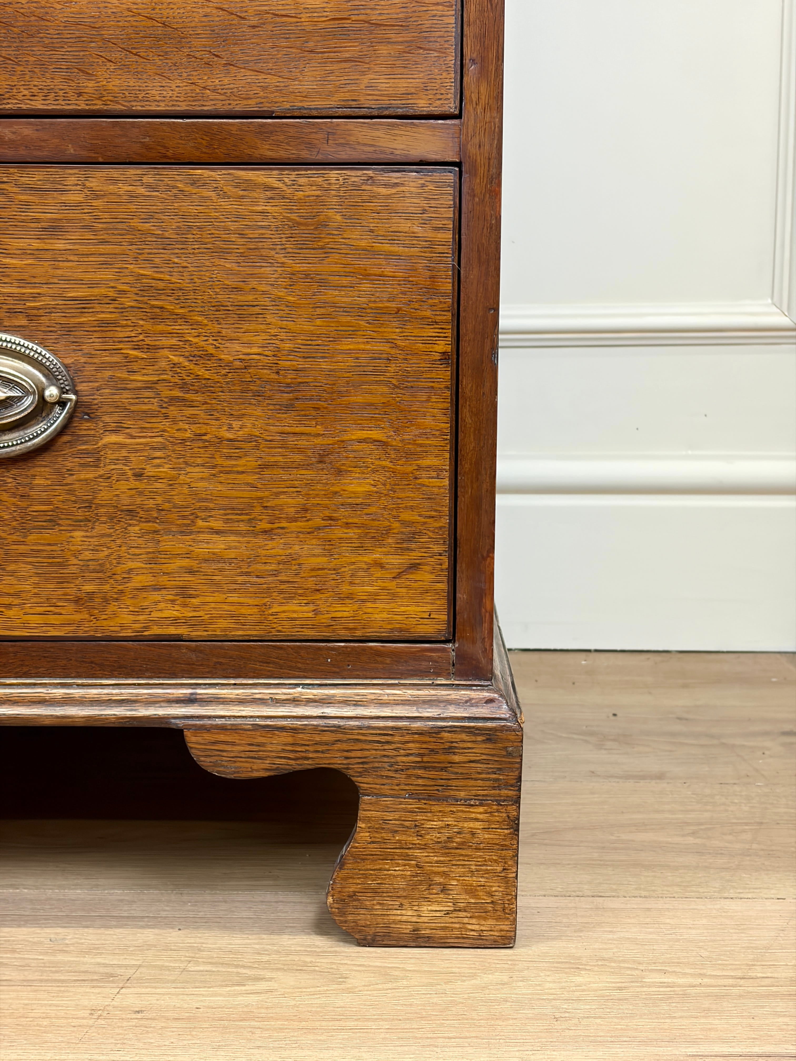 Wooden drawer with a metal handle on a wooden floor.