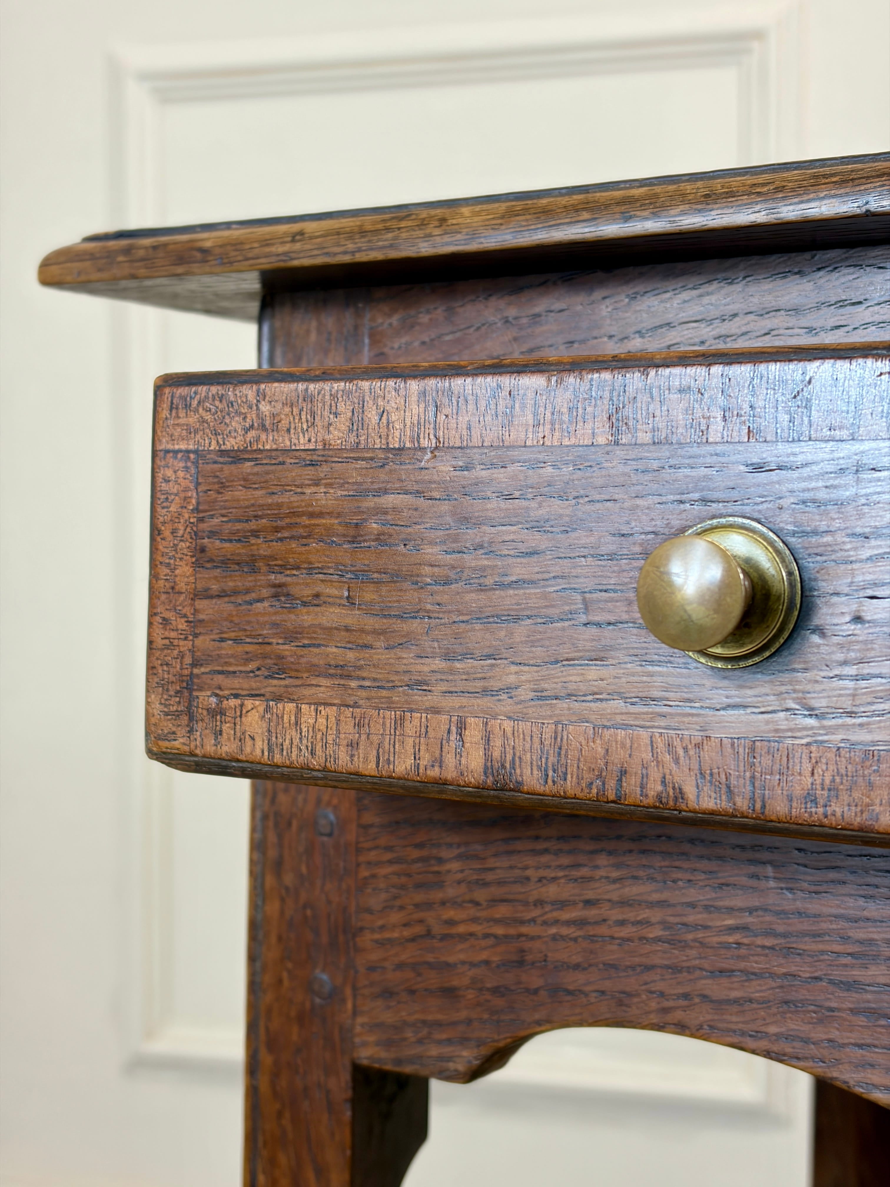 Close-up of a wooden drawer with a brass handle on a white background