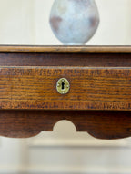 Wooden box with a brass lock on a white background