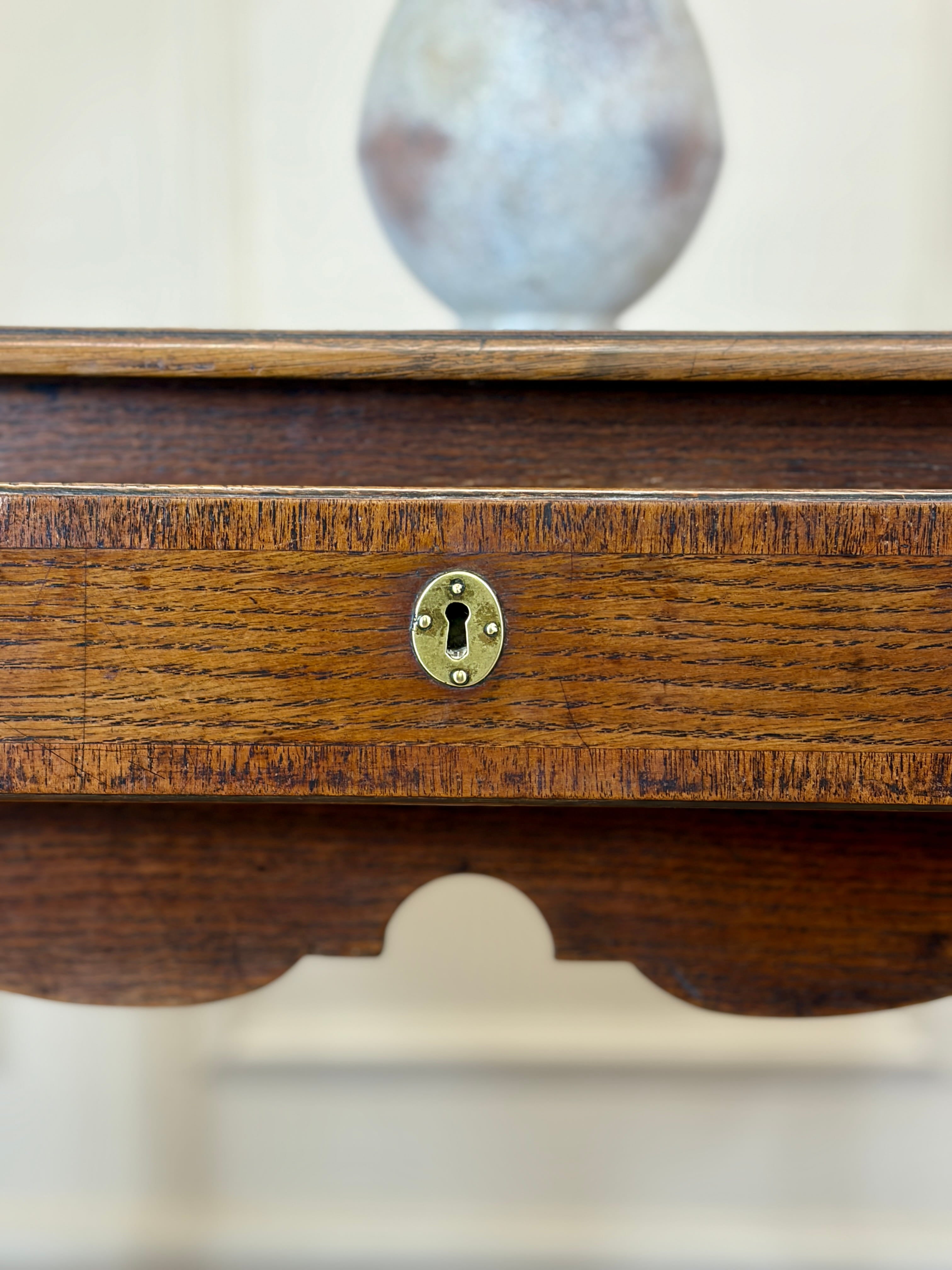Wooden box with a brass lock on a white background
