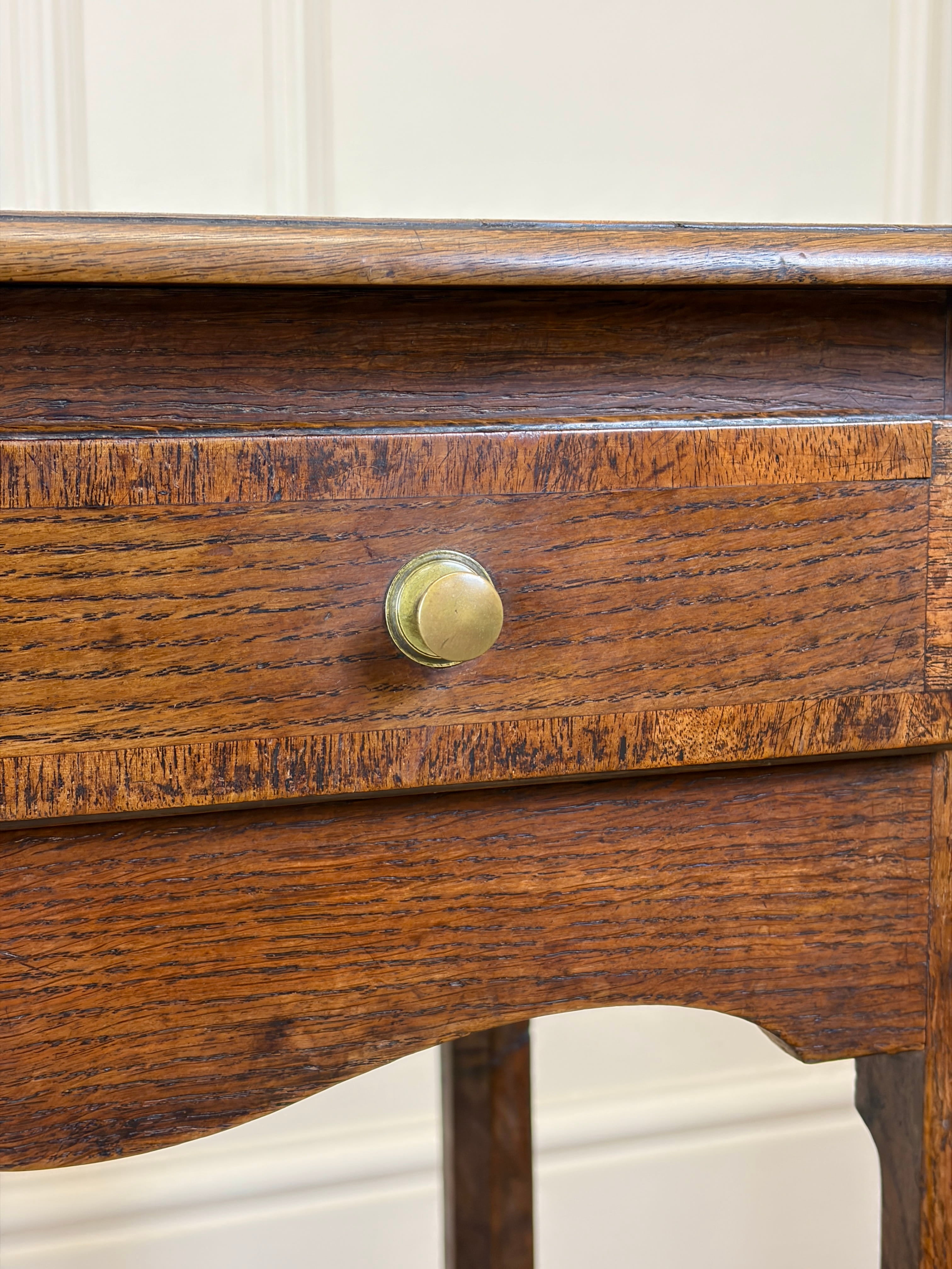 Close-up of a wooden drawer with a brass knob against a white background