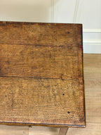 Close-up of a wooden surface with visible grain and texture.