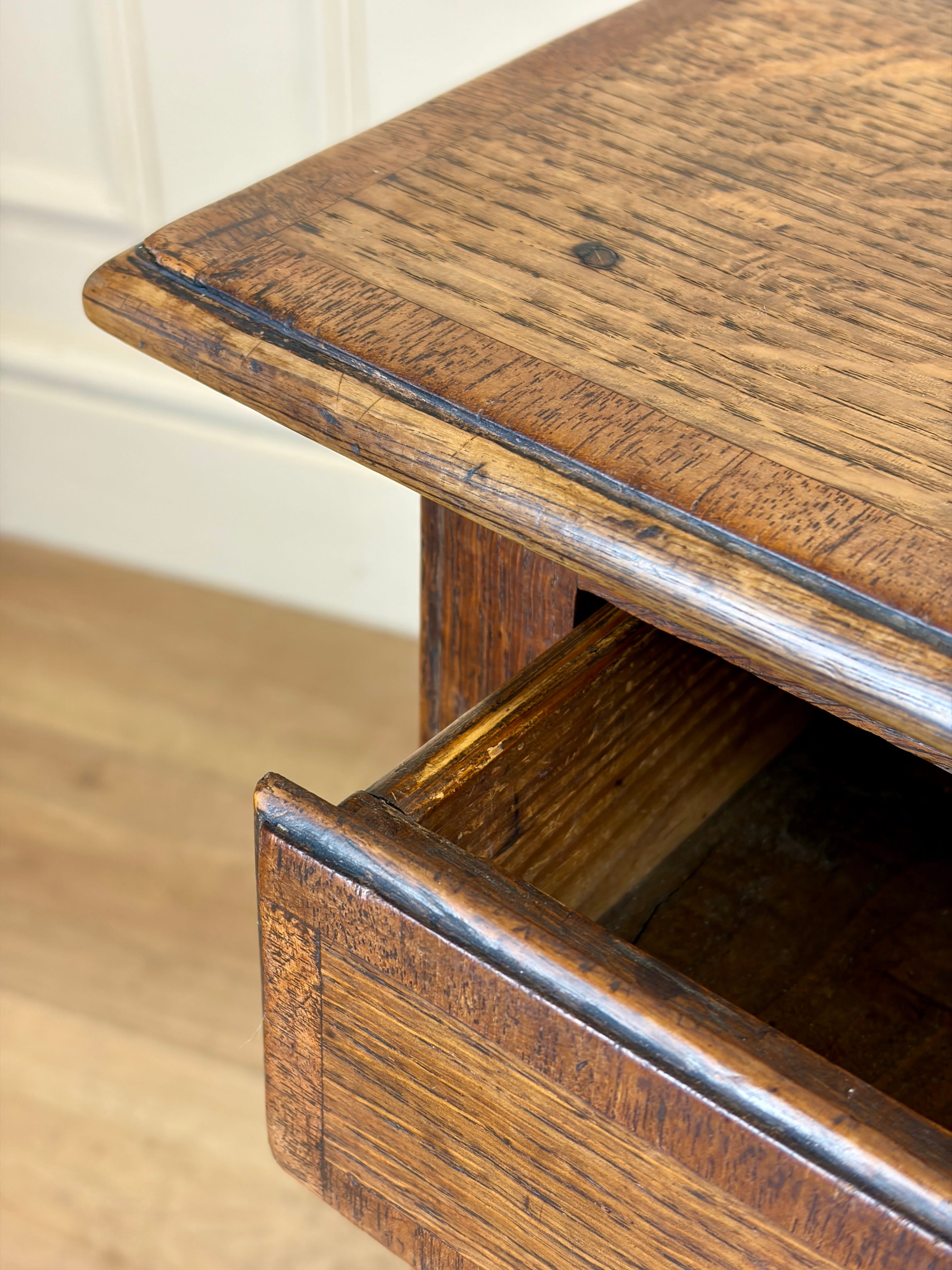 Wooden drawer with a partially open lid on a wooden floor.