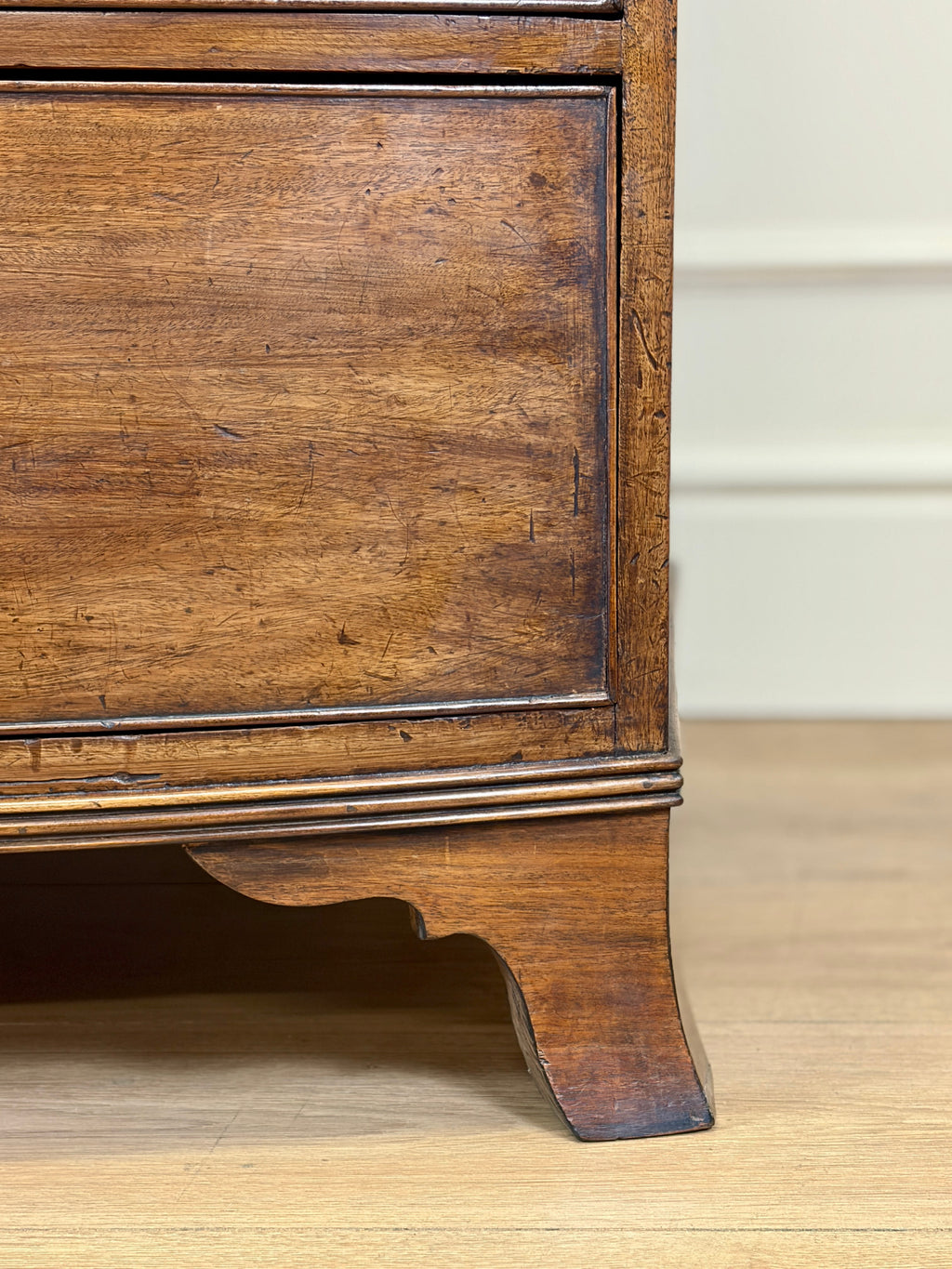 Close-up of a wooden cabinet with a light background