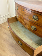 Wooden dresser with open drawer on a wooden floor