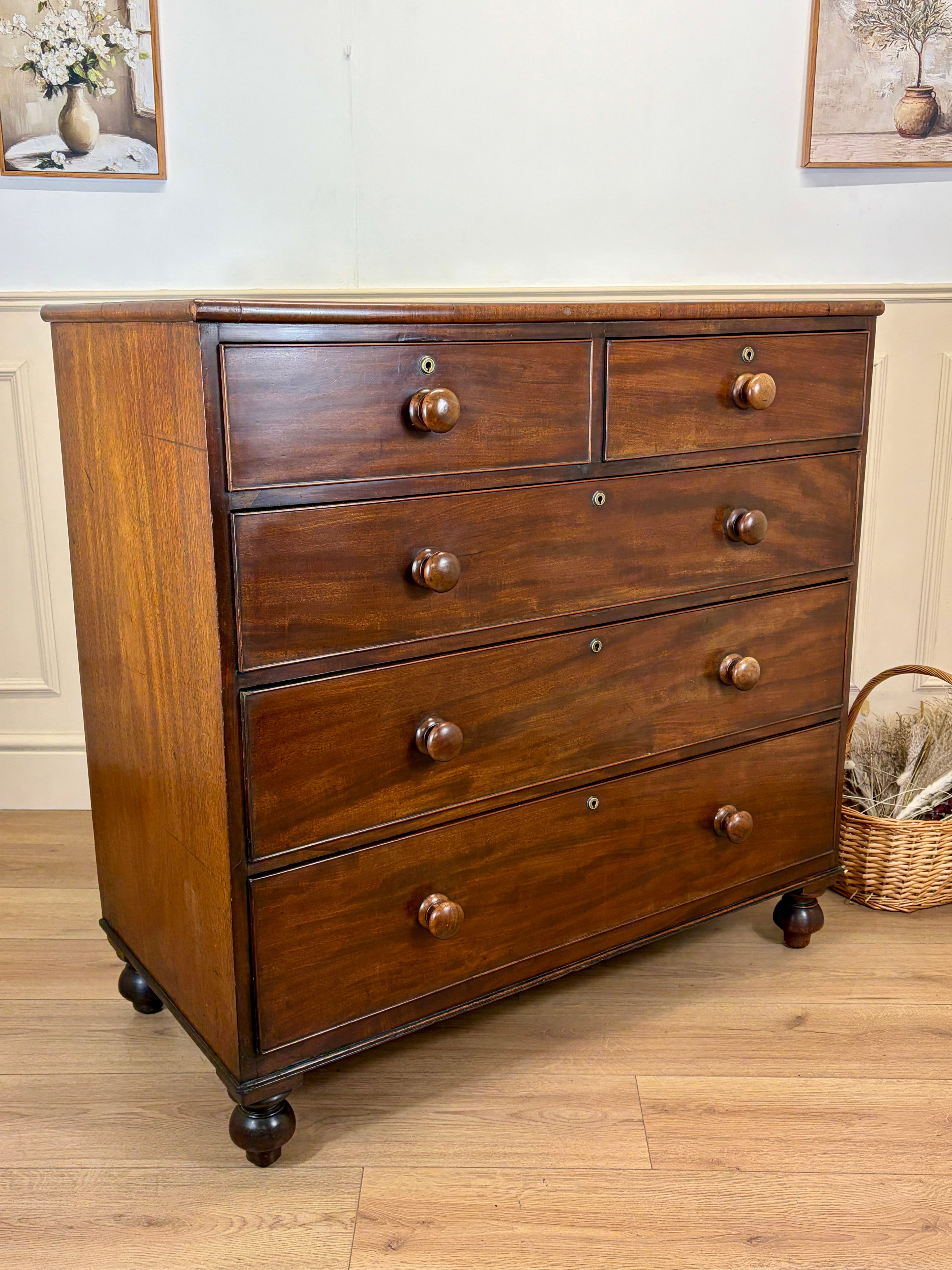 Wooden dresser with multiple drawers on a wooden floor.