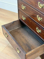 Wooden dresser with open drawer on a wooden floor