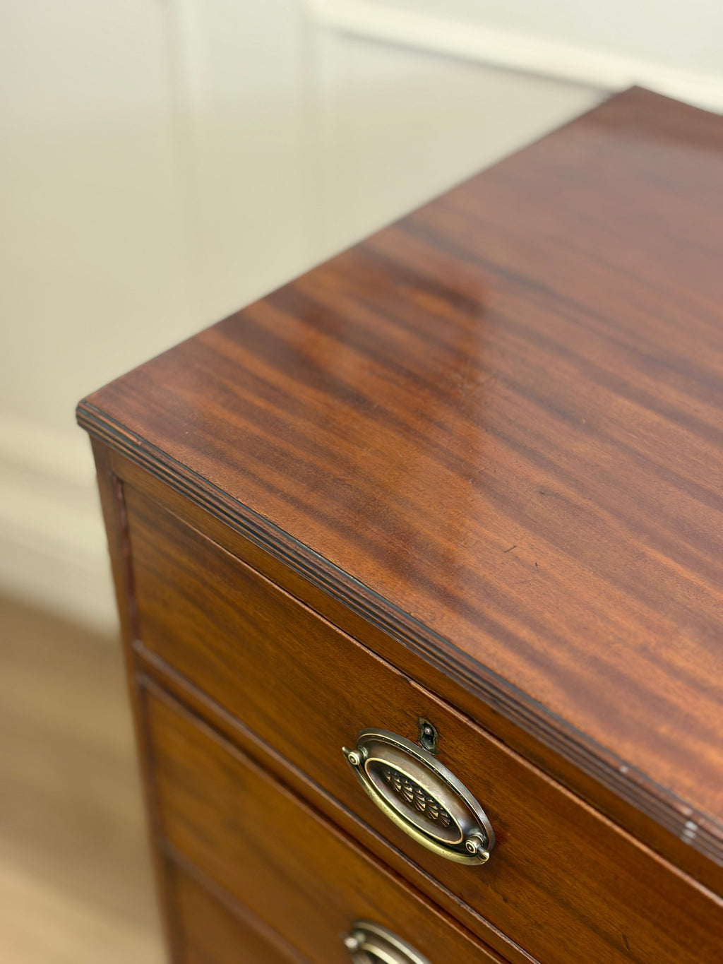 Wooden drawer with brass handle on a blurred background