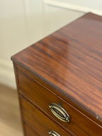 Wooden drawer with brass handle on a blurred background