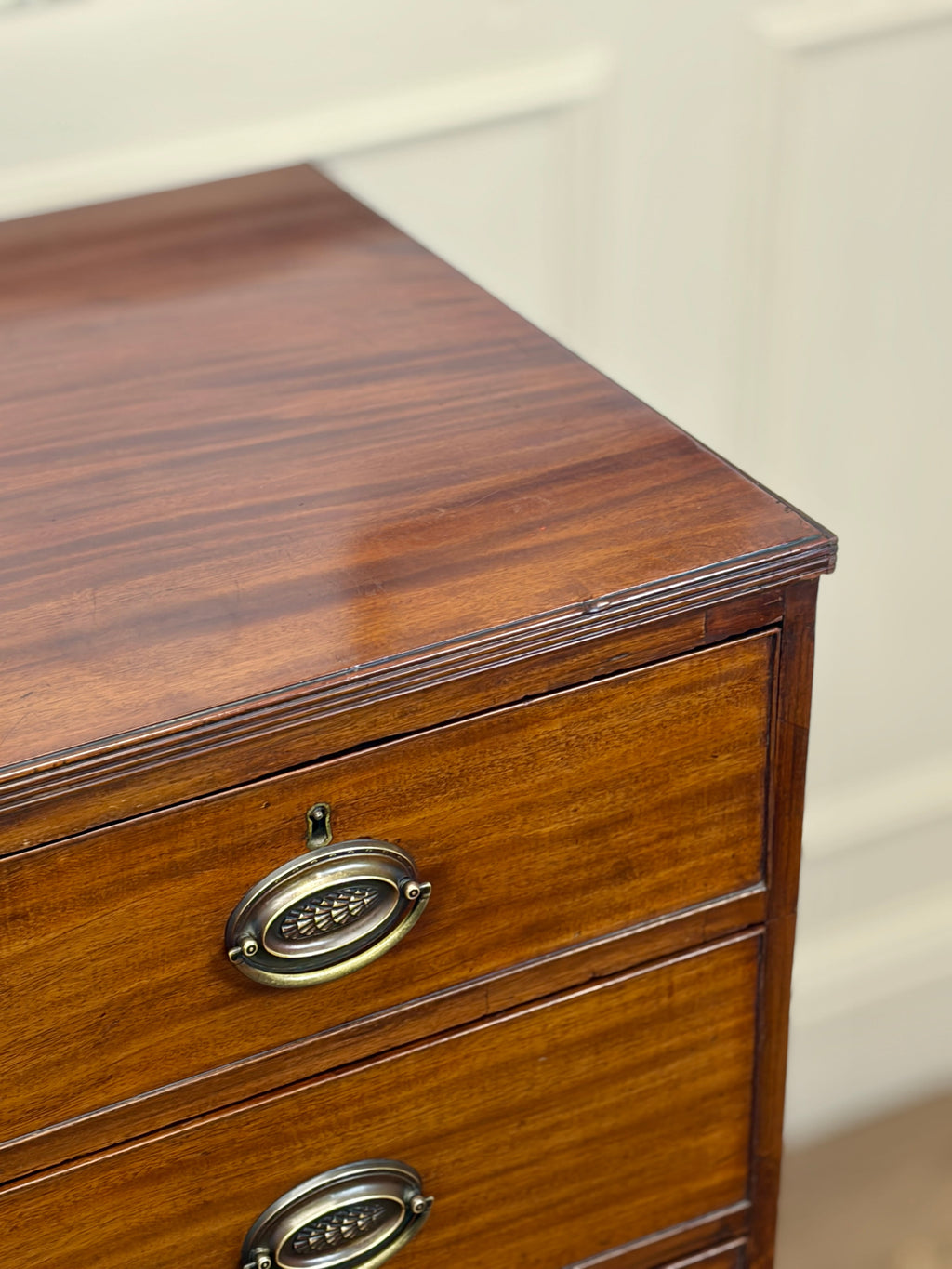 Wooden drawer with brass handles on a white background