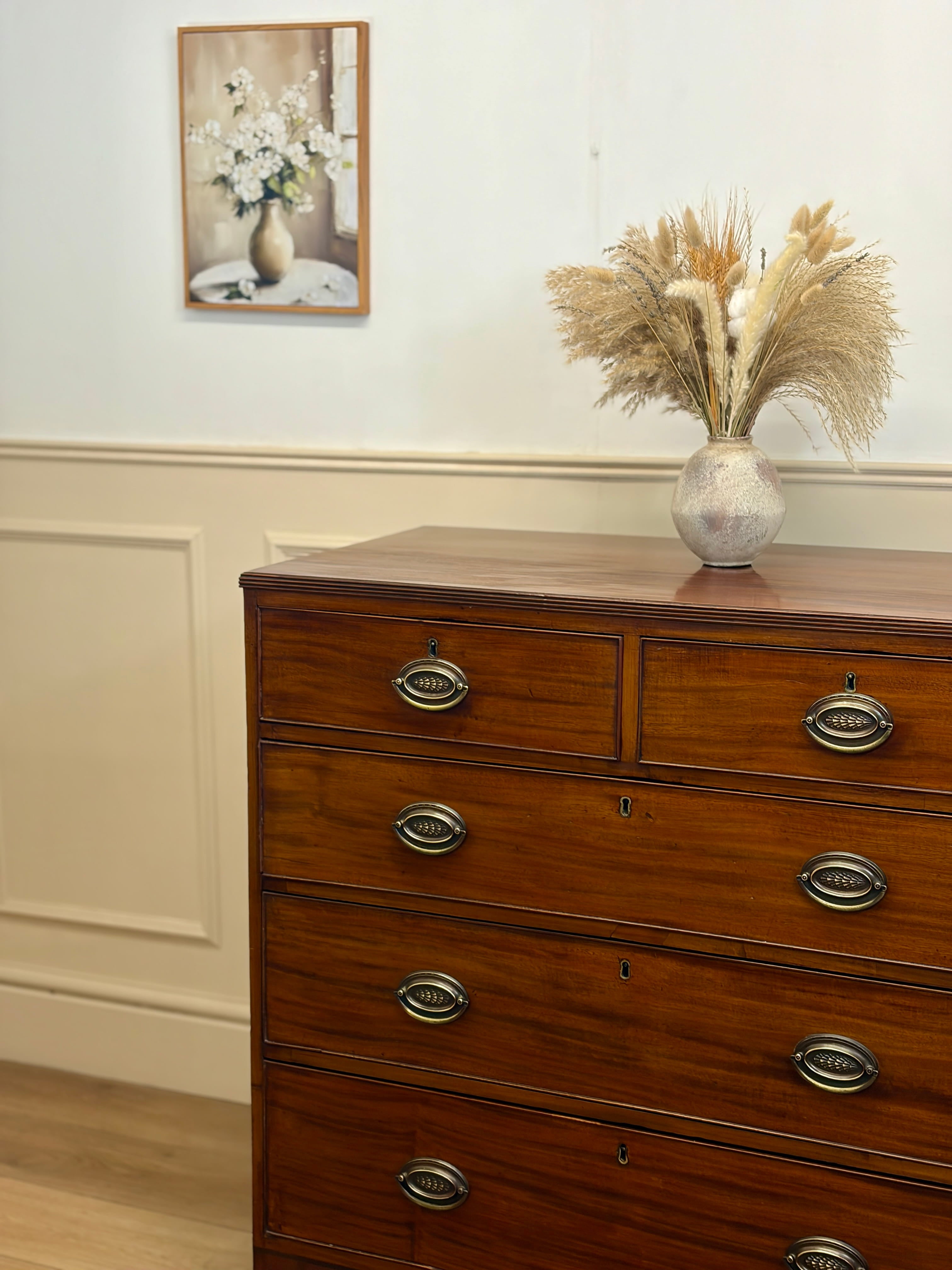 Wooden dresser with decorative items in a room setting