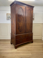 Antique Georgian mahogany tall slim wardrobe with drawers and oval panel doors on ogee bracket feet