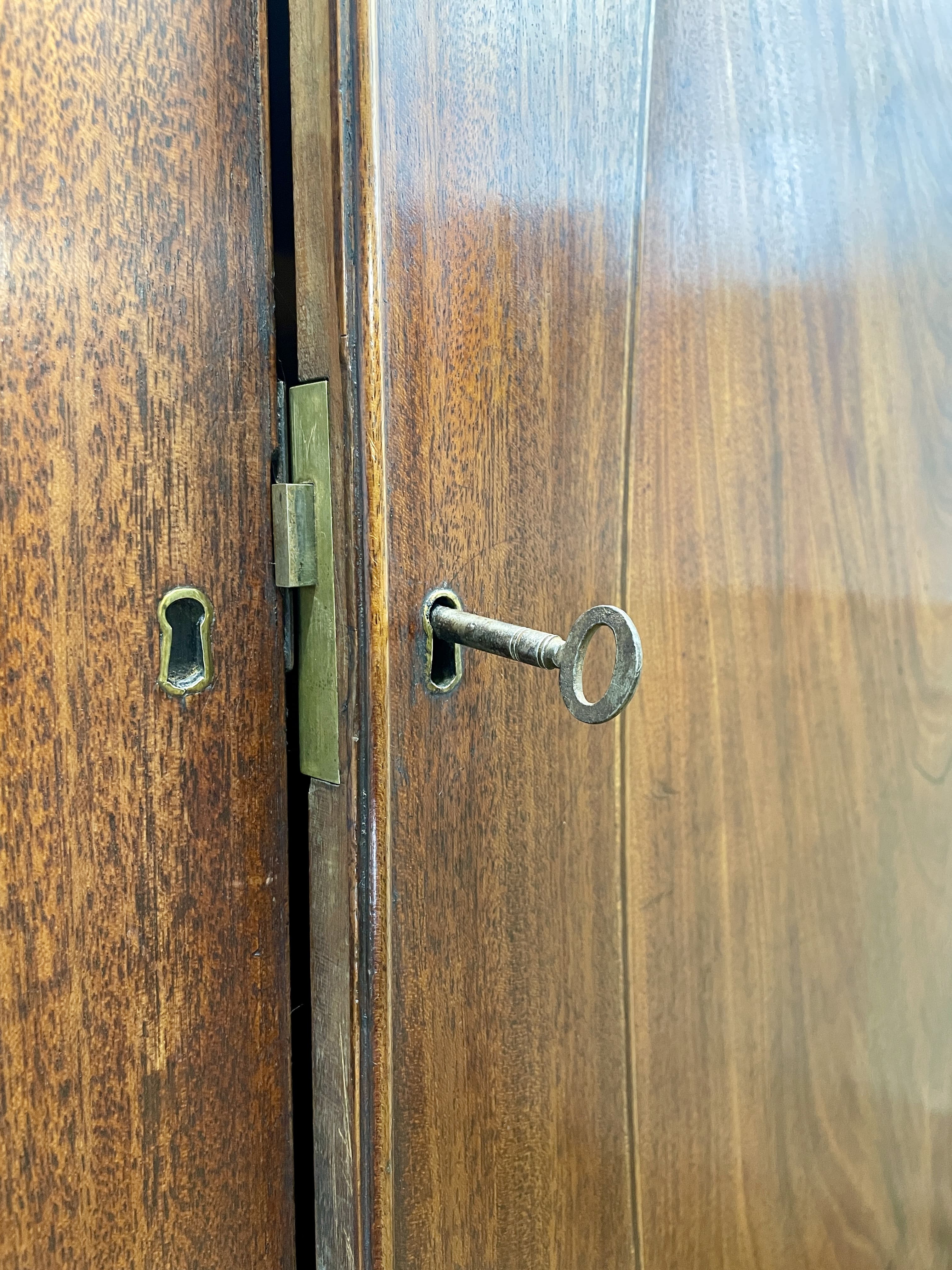 Antique Georgian mahogany tall slim wardrobe with drawers and oval panel doors on ogee bracket feet