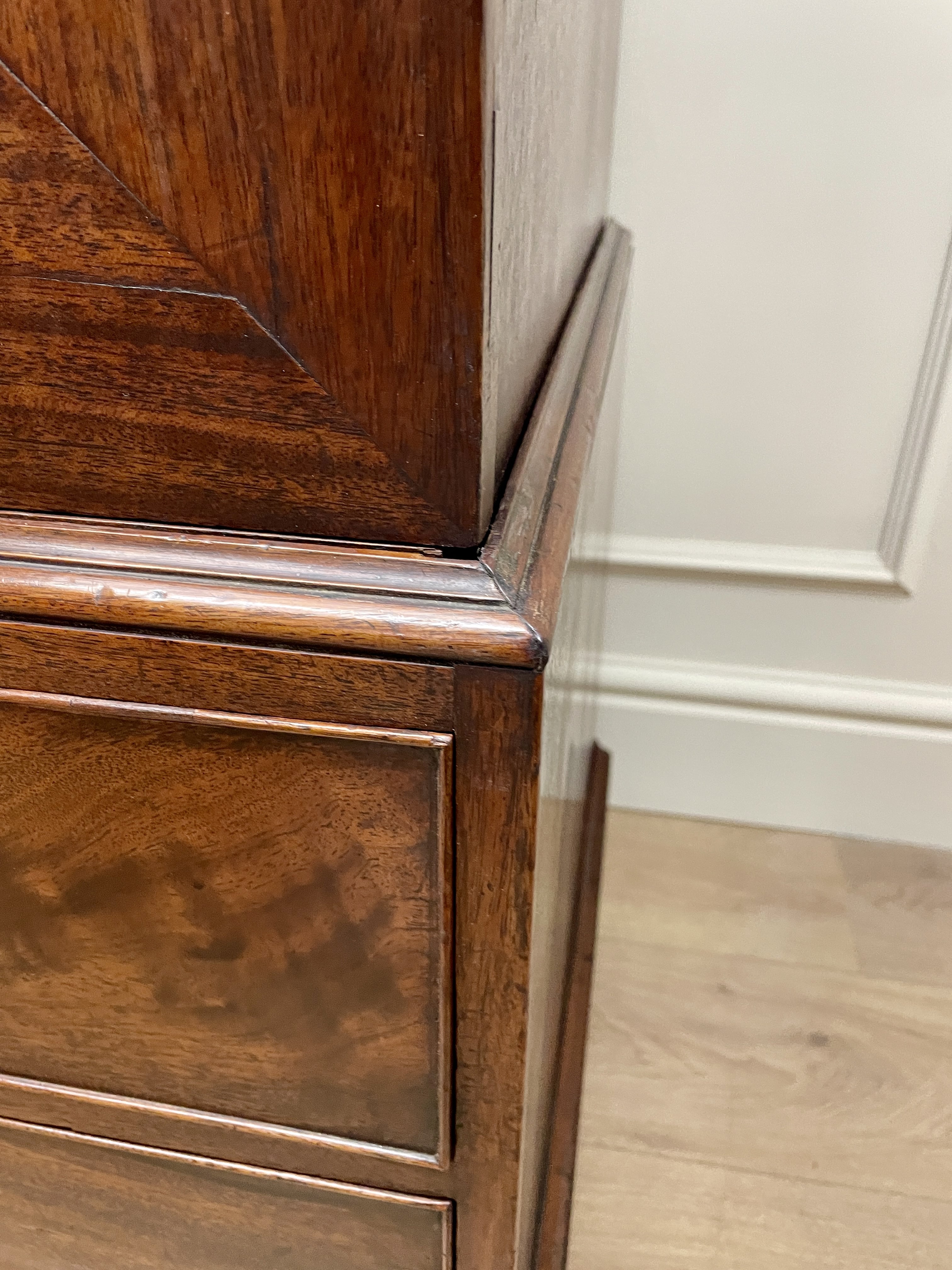 Antique Georgian mahogany tall slim wardrobe with drawers and oval panel doors on ogee bracket feet