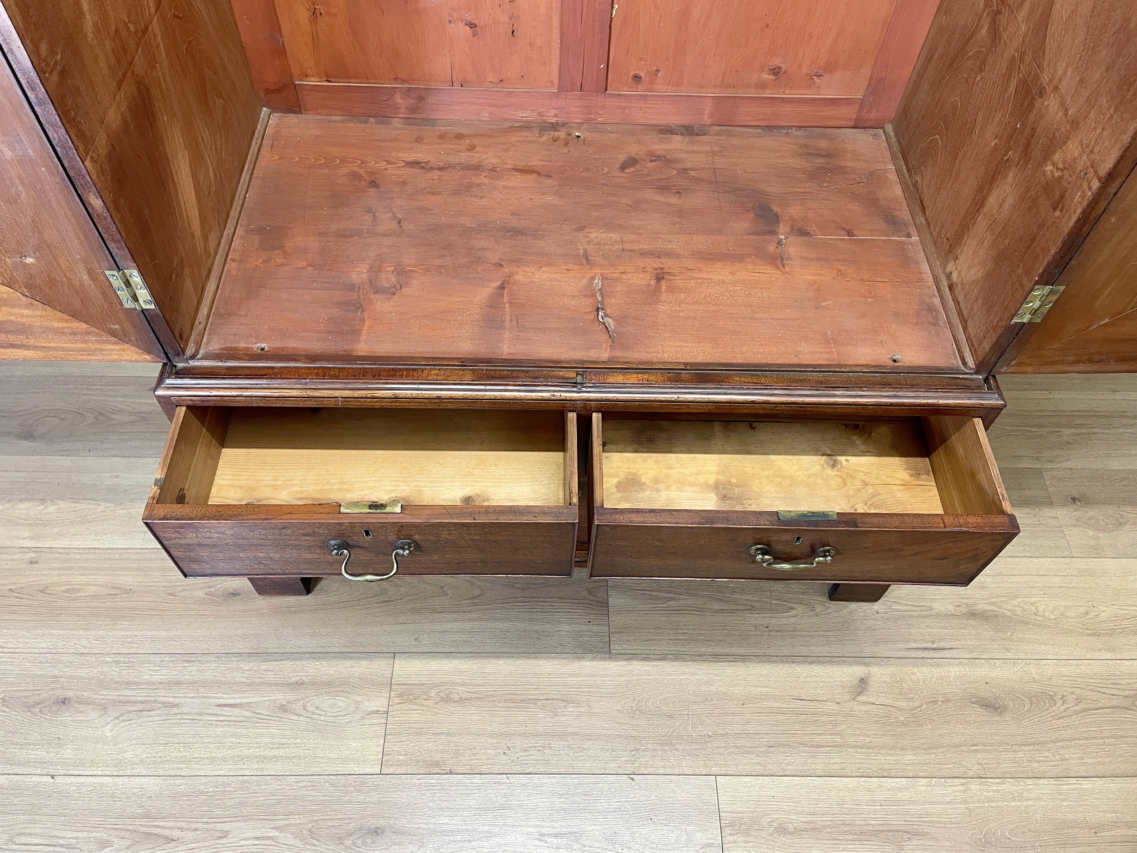 Antique Georgian mahogany tall slim wardrobe with drawers and oval panel doors on ogee bracket feet