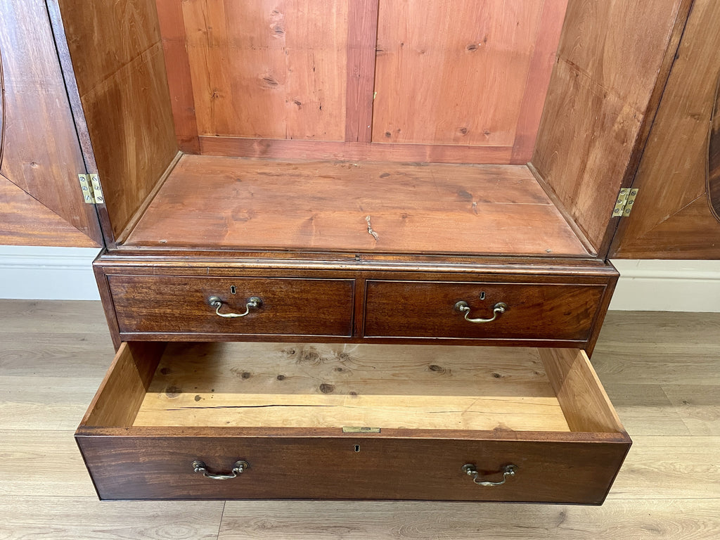 Antique Georgian mahogany tall slim wardrobe with drawers and oval panel doors on ogee bracket feet