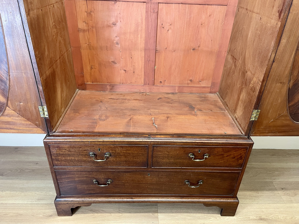Antique Georgian mahogany tall slim wardrobe with drawers and oval panel doors on ogee bracket feet