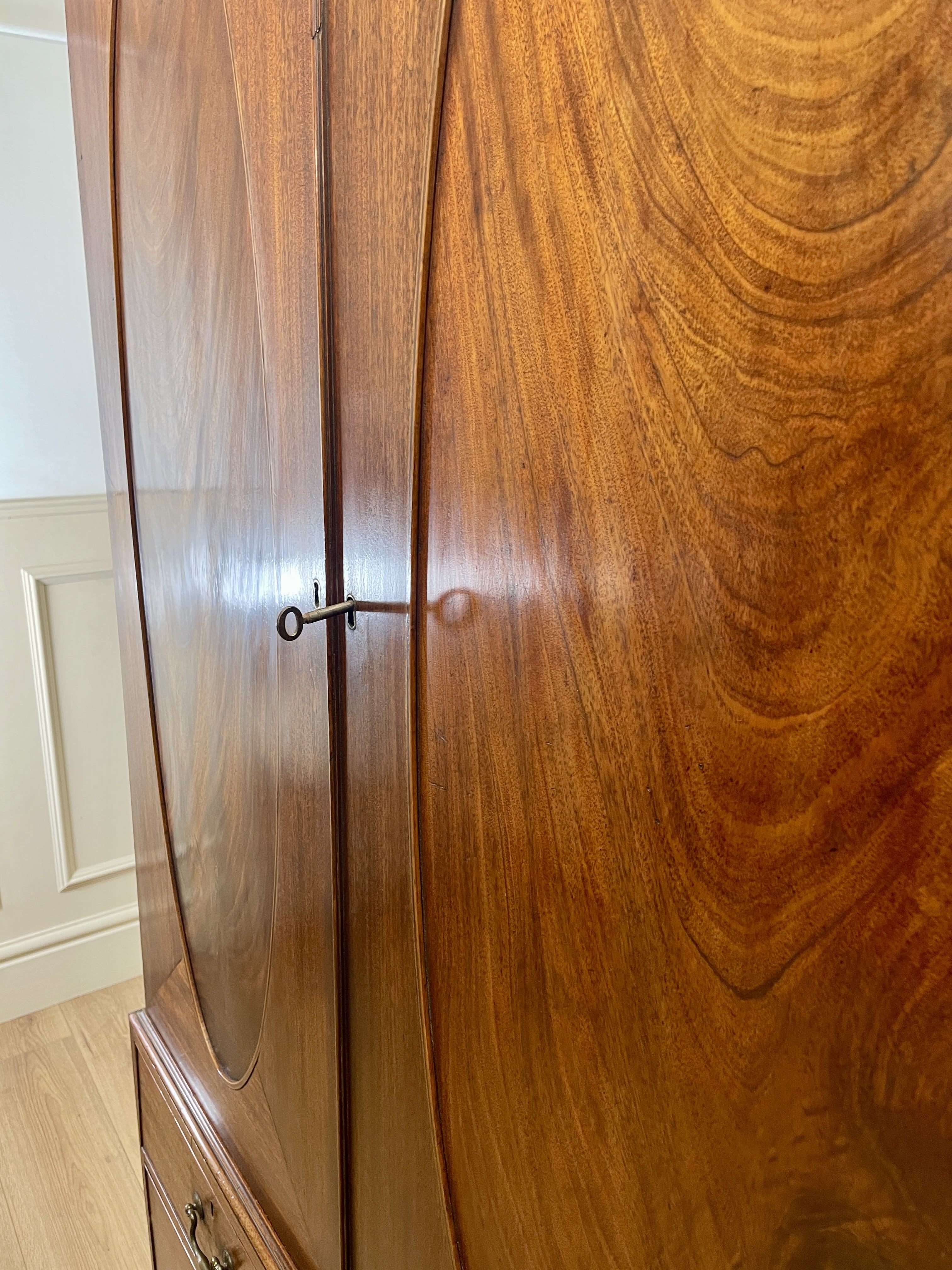 Antique Georgian mahogany tall slim wardrobe with drawers and oval panel doors on ogee bracket feet