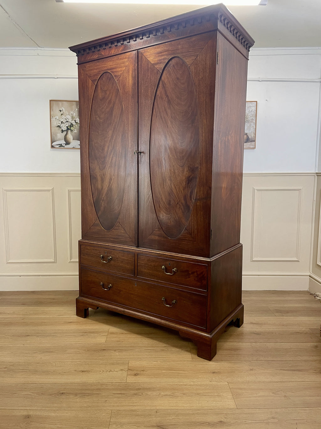 Antique Georgian mahogany tall slim wardrobe with drawers and oval panel doors on ogee bracket feet
