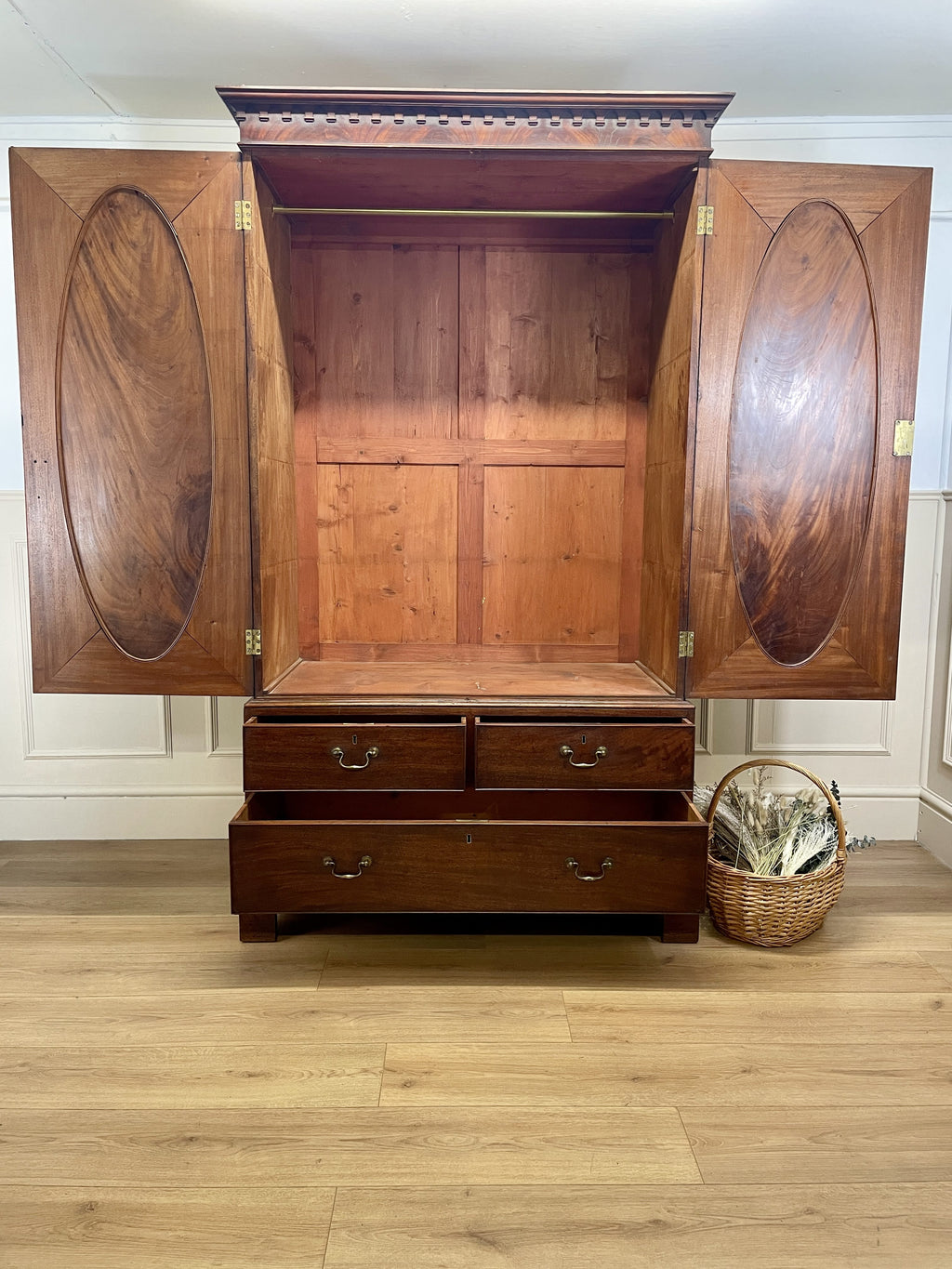 Antique Georgian mahogany tall slim wardrobe with drawers and oval panel doors on ogee bracket feet