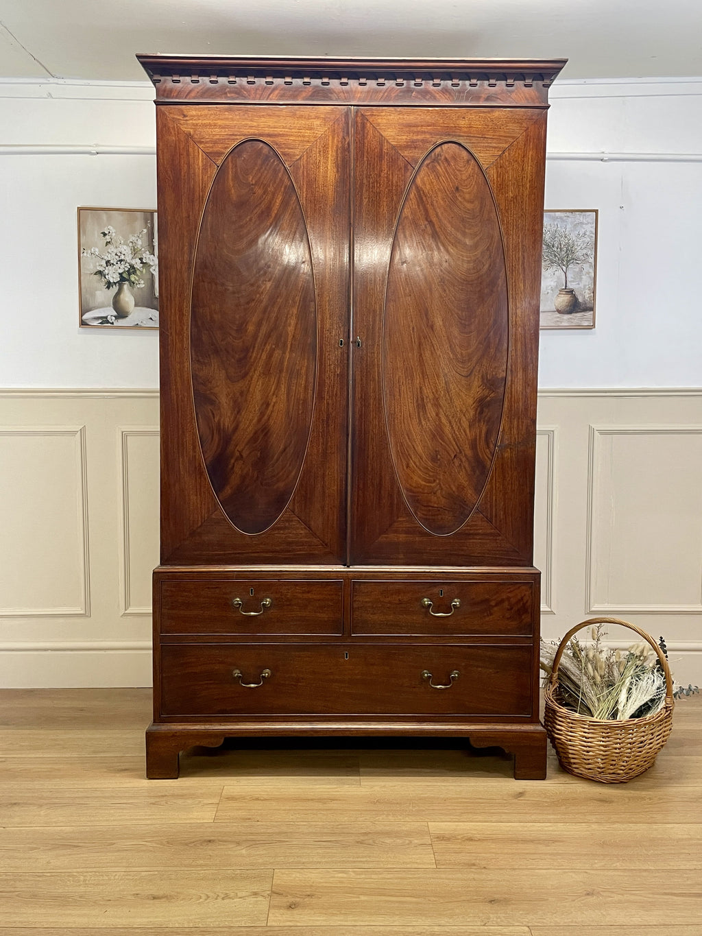 Antique Georgian mahogany tall slim wardrobe with drawers and oval panel doors on ogee bracket feet