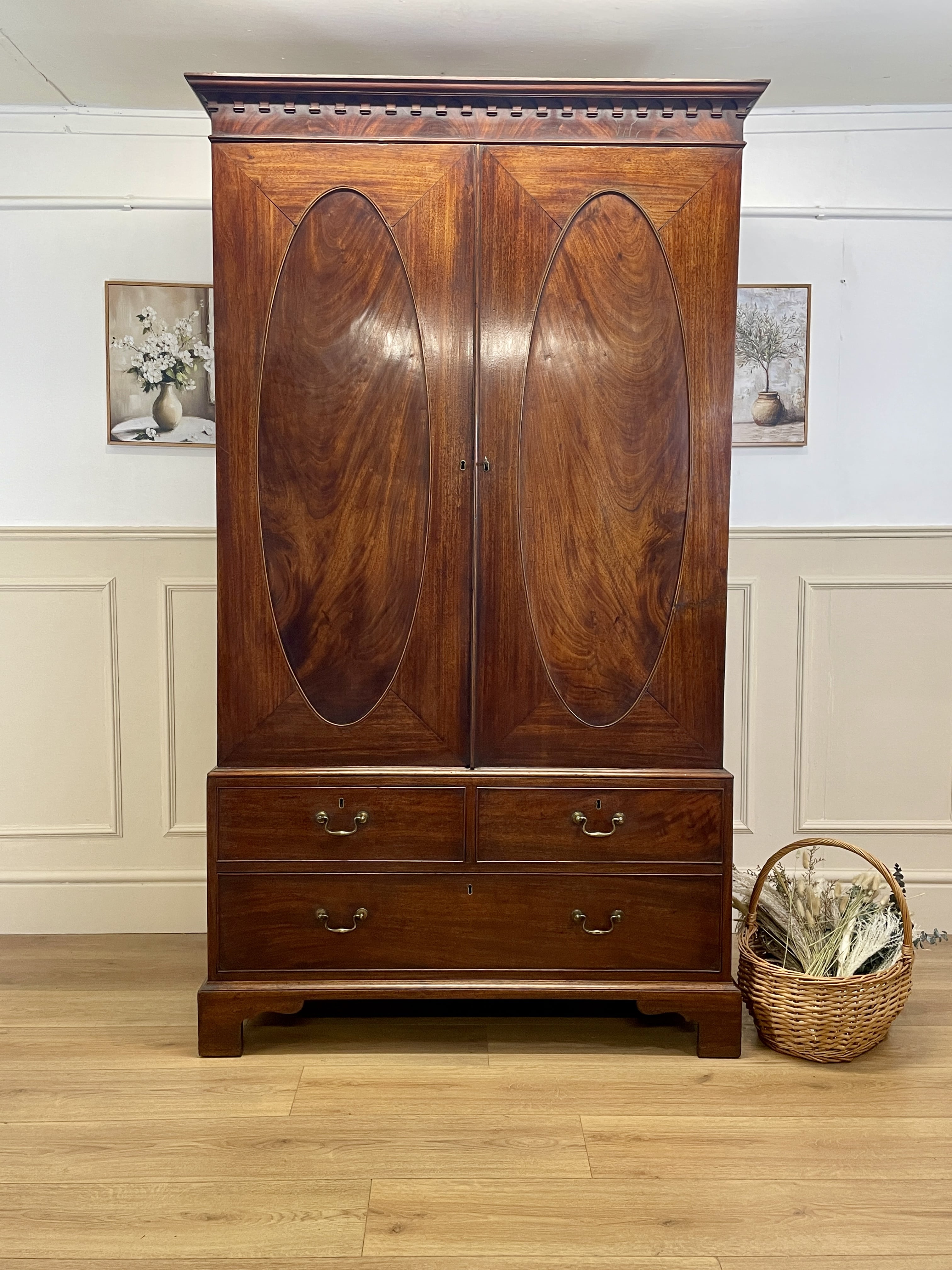 Antique Georgian mahogany tall slim wardrobe with drawers and oval panel doors on ogee bracket feet
