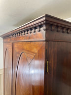 Antique Georgian mahogany tall slim wardrobe with drawers and oval panel doors on ogee bracket feet