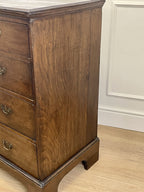 Mid-18th century antique Georgian oak chest of drawers with caddy moulded top, two short and three long graduated drawers, original brass handles, and bracket feet.
