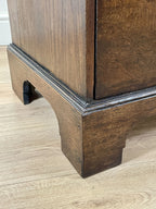 Mid-18th century antique Georgian oak chest of drawers with caddy moulded top, two short and three long graduated drawers, original brass handles, and bracket feet.