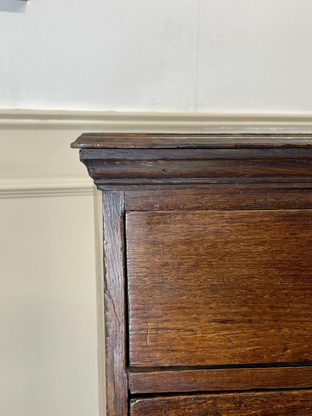 Mid-18th century antique Georgian oak chest of drawers with caddy moulded top, two short and three long graduated drawers, original brass handles, and bracket feet.