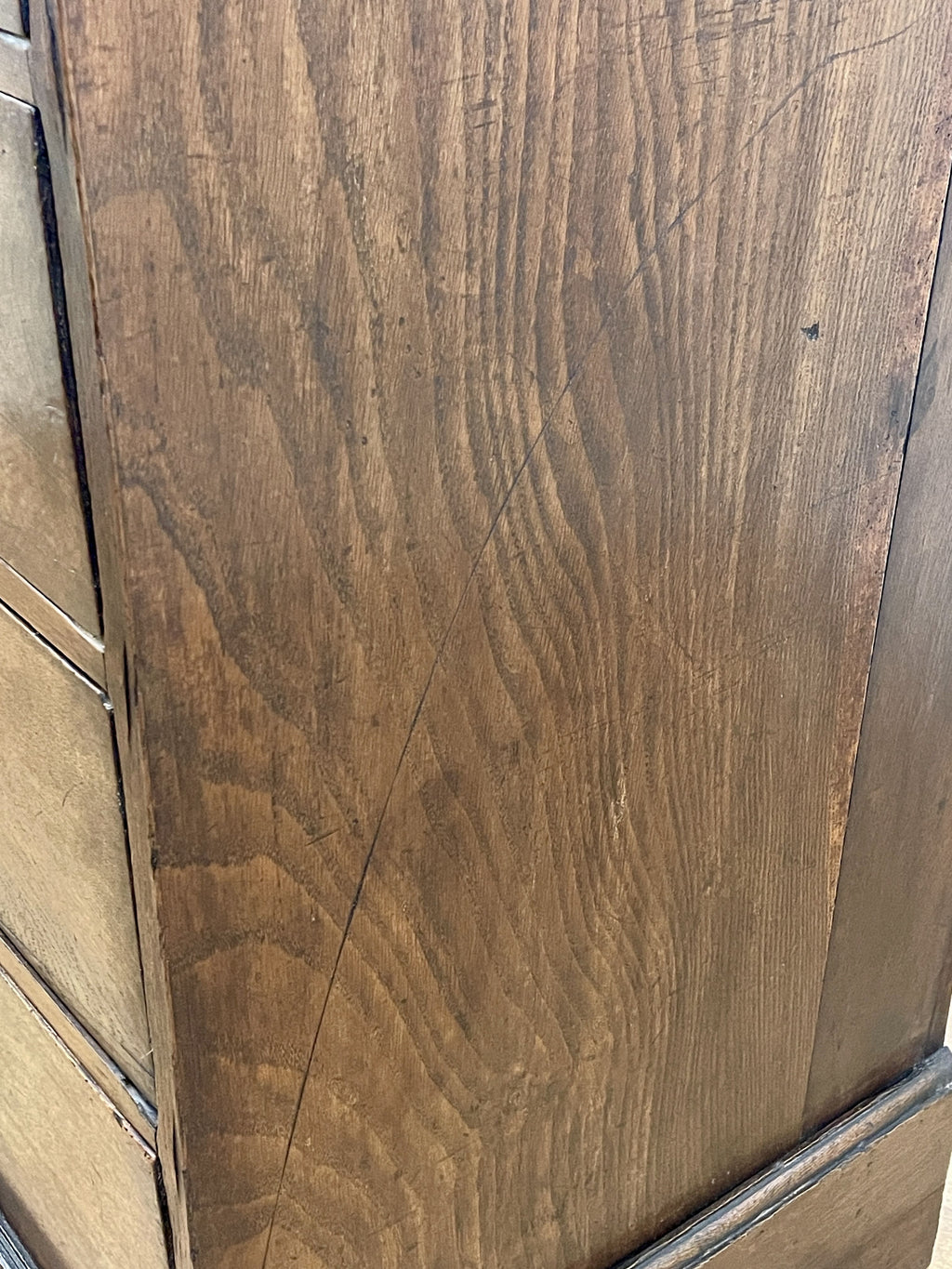 Mid-18th century antique Georgian oak chest of drawers with caddy moulded top, two short and three long graduated drawers, original brass handles, and bracket feet.