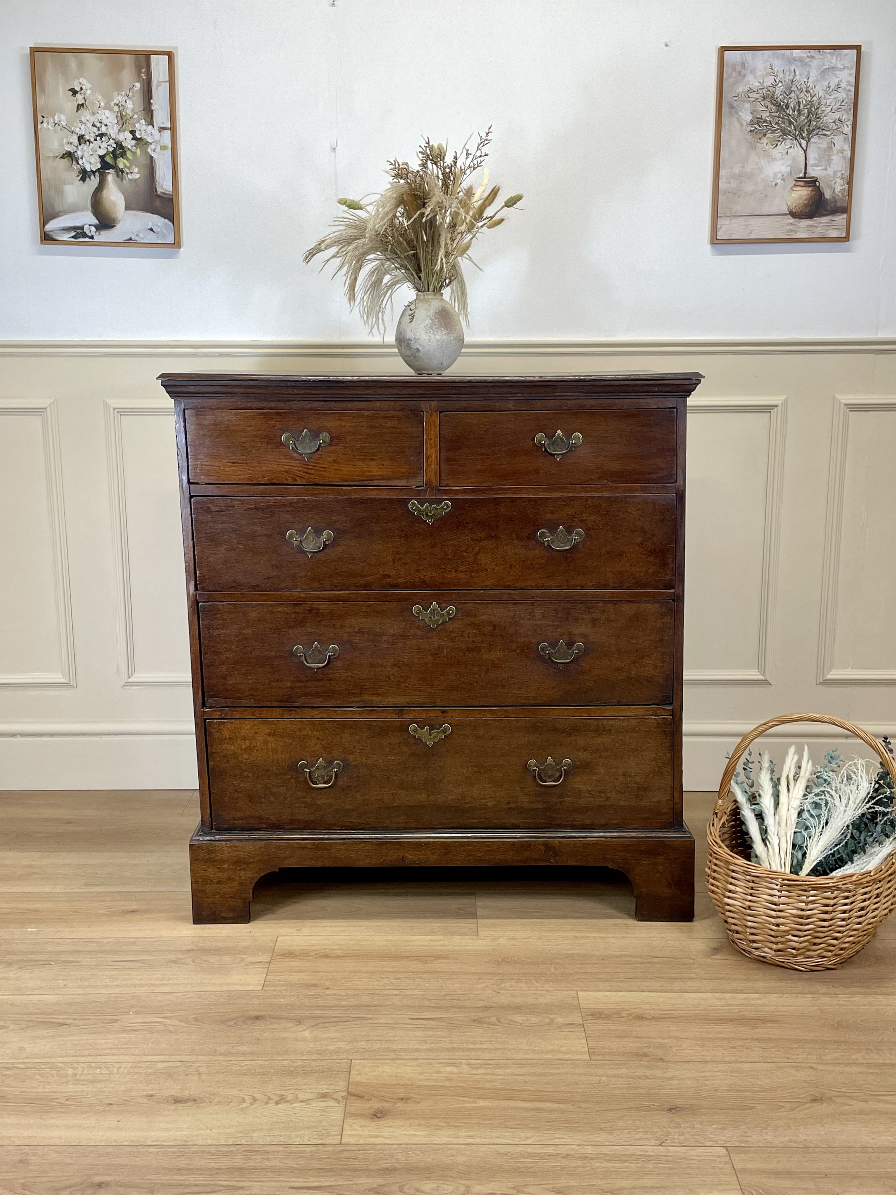 Mid-18th century antique Georgian oak chest of drawers with caddy moulded top, two short and three long graduated drawers, original brass handles, and bracket feet.