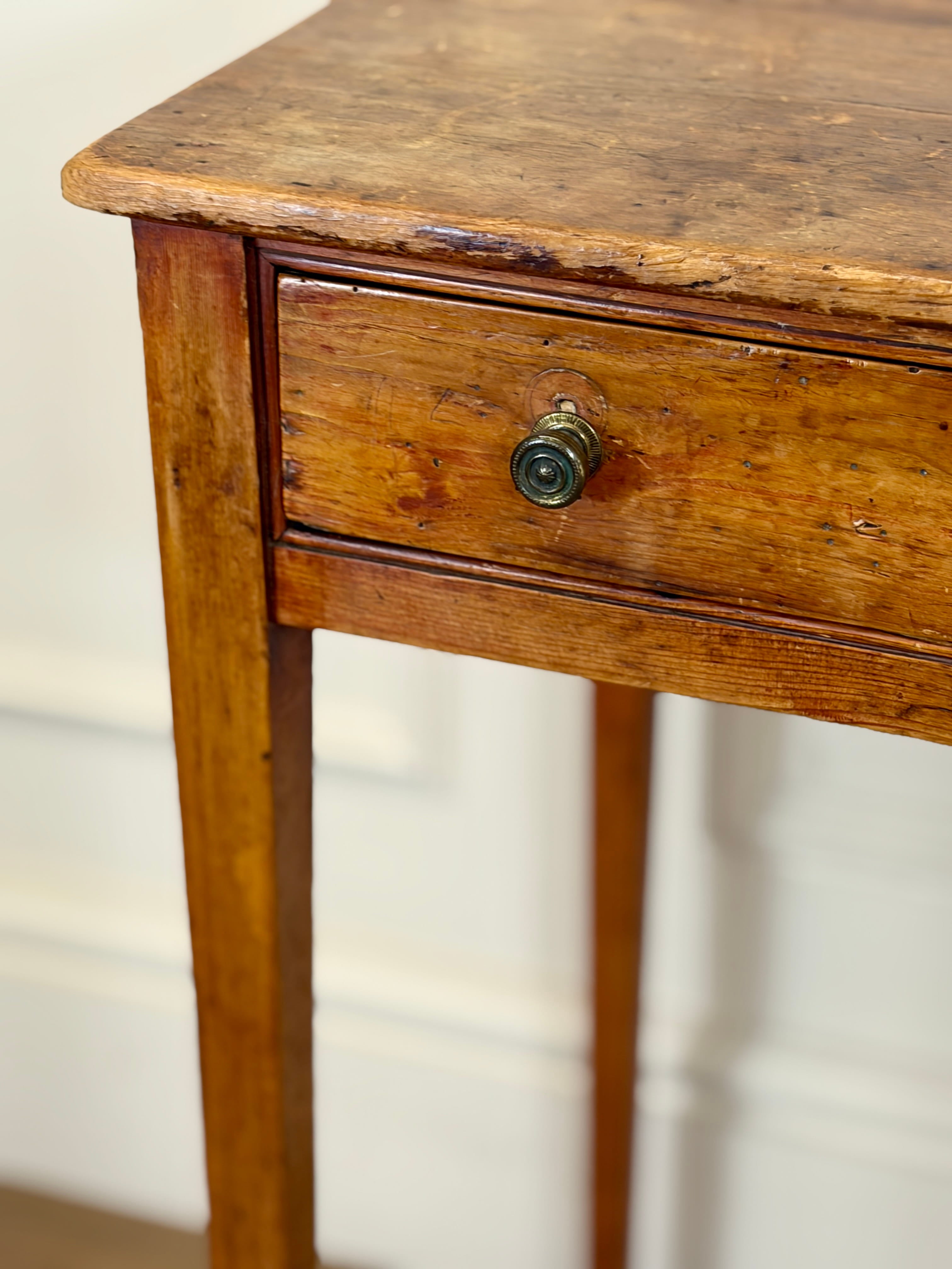 Wooden side table with a single drawer and metal handle on a white background
