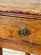 Close-up of a wooden drawer with a brass handle