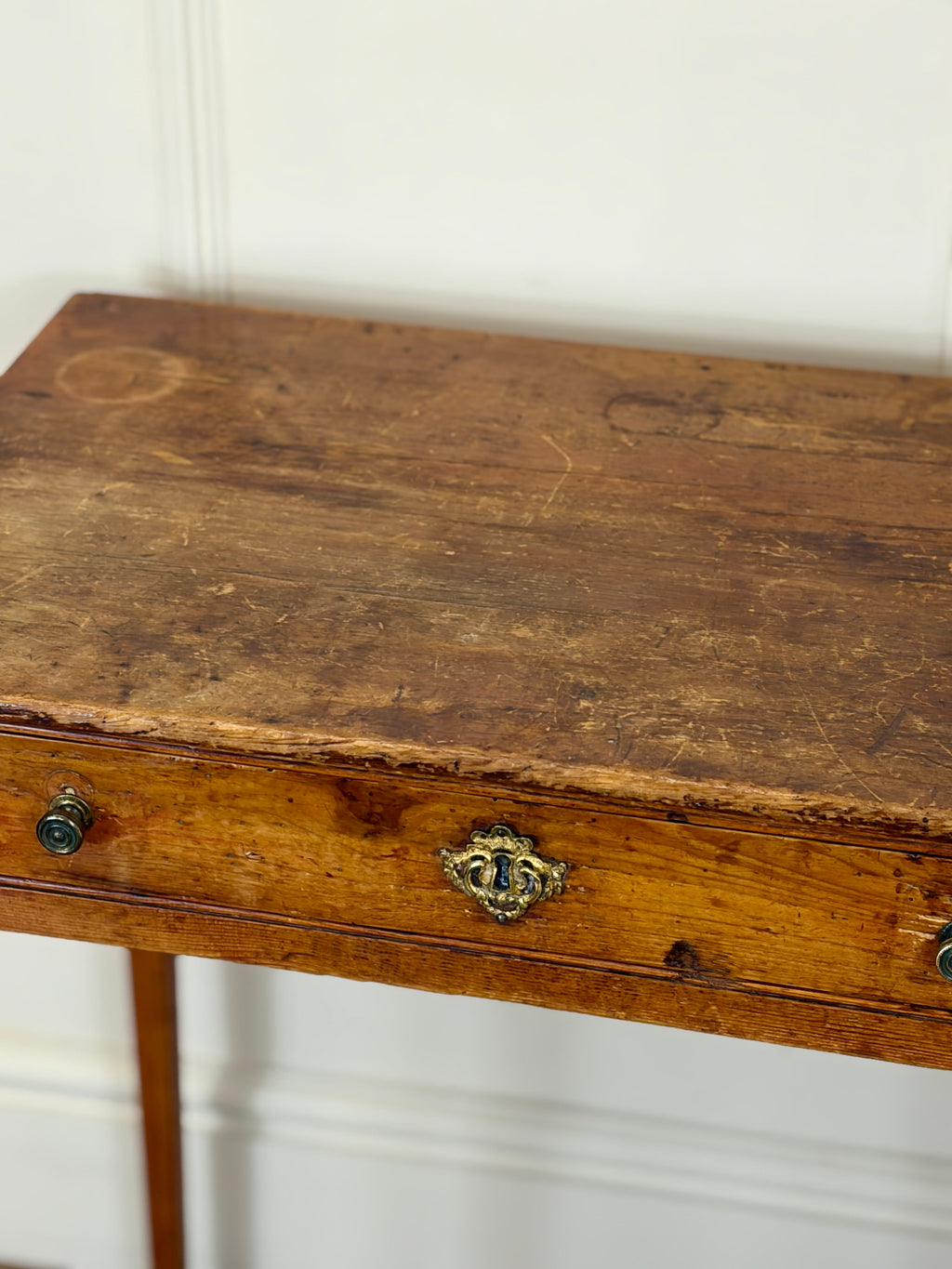 Wooden table with a decorative knob on a white background