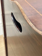 Close-up of a wooden surface with a circular hole and a handle.