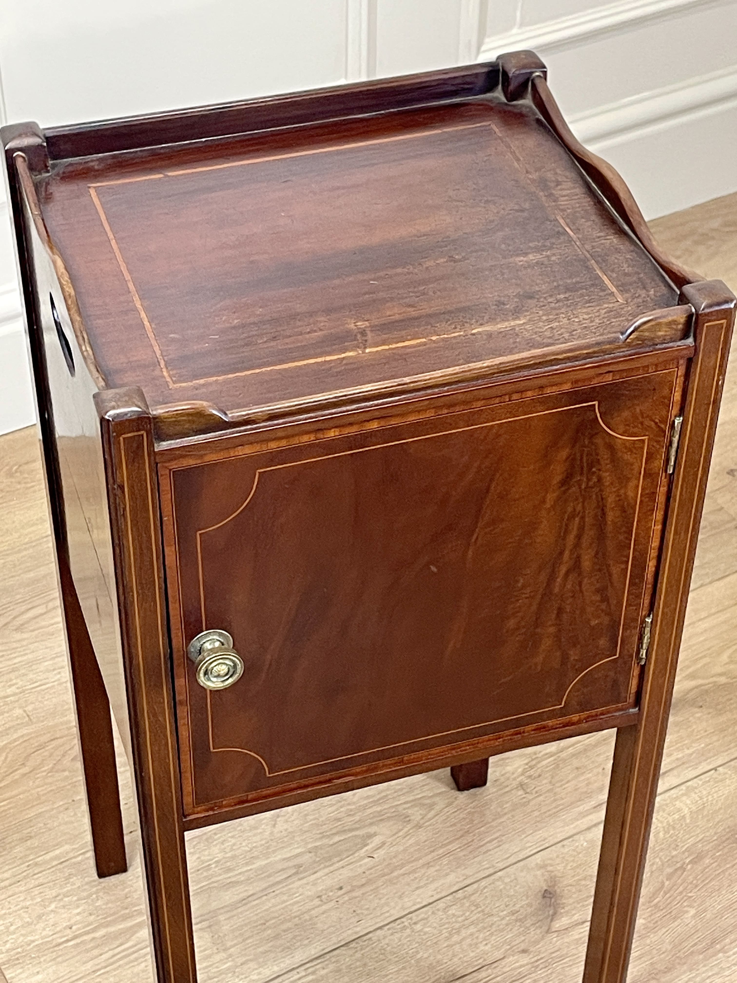 Wooden side table with a cabinet on a wooden floor