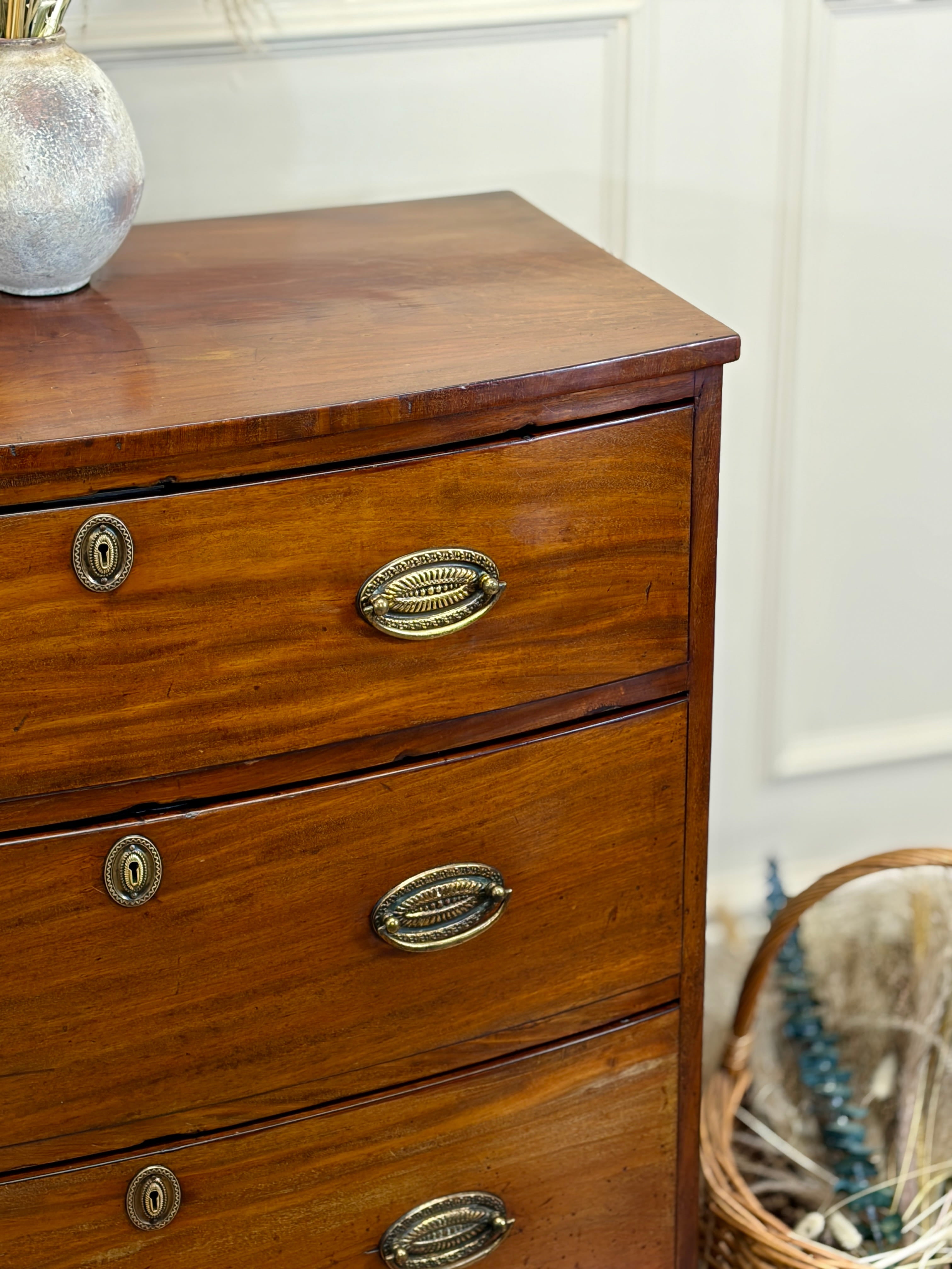Wooden dresser with brass handles in a room setting