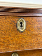 Close-up of a wooden drawer with a brass keyhole