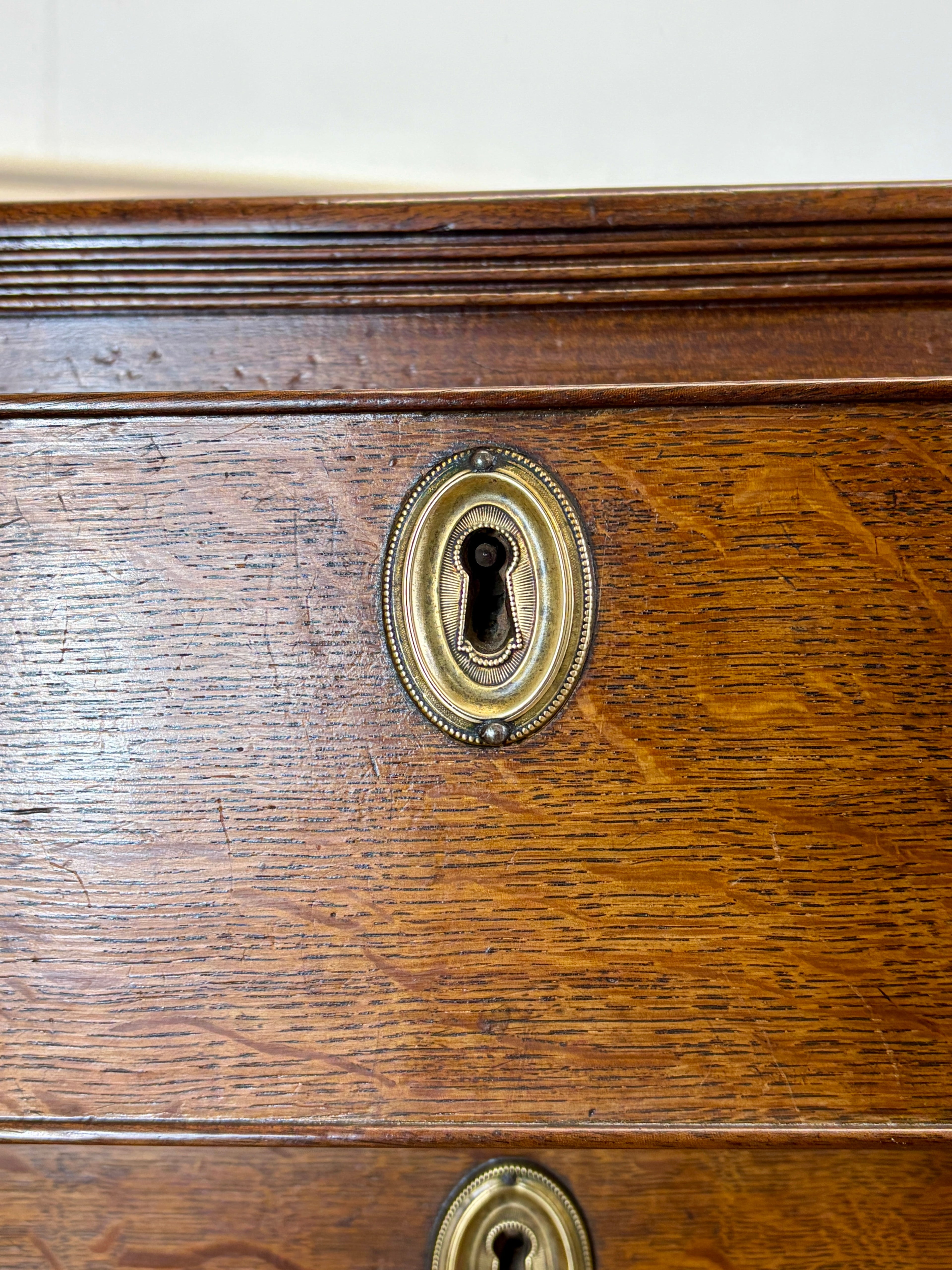 Close-up of a wooden door with a brass keyhole and lock.