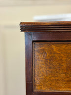 Close-up of a wooden cabinet corner with a blurred background