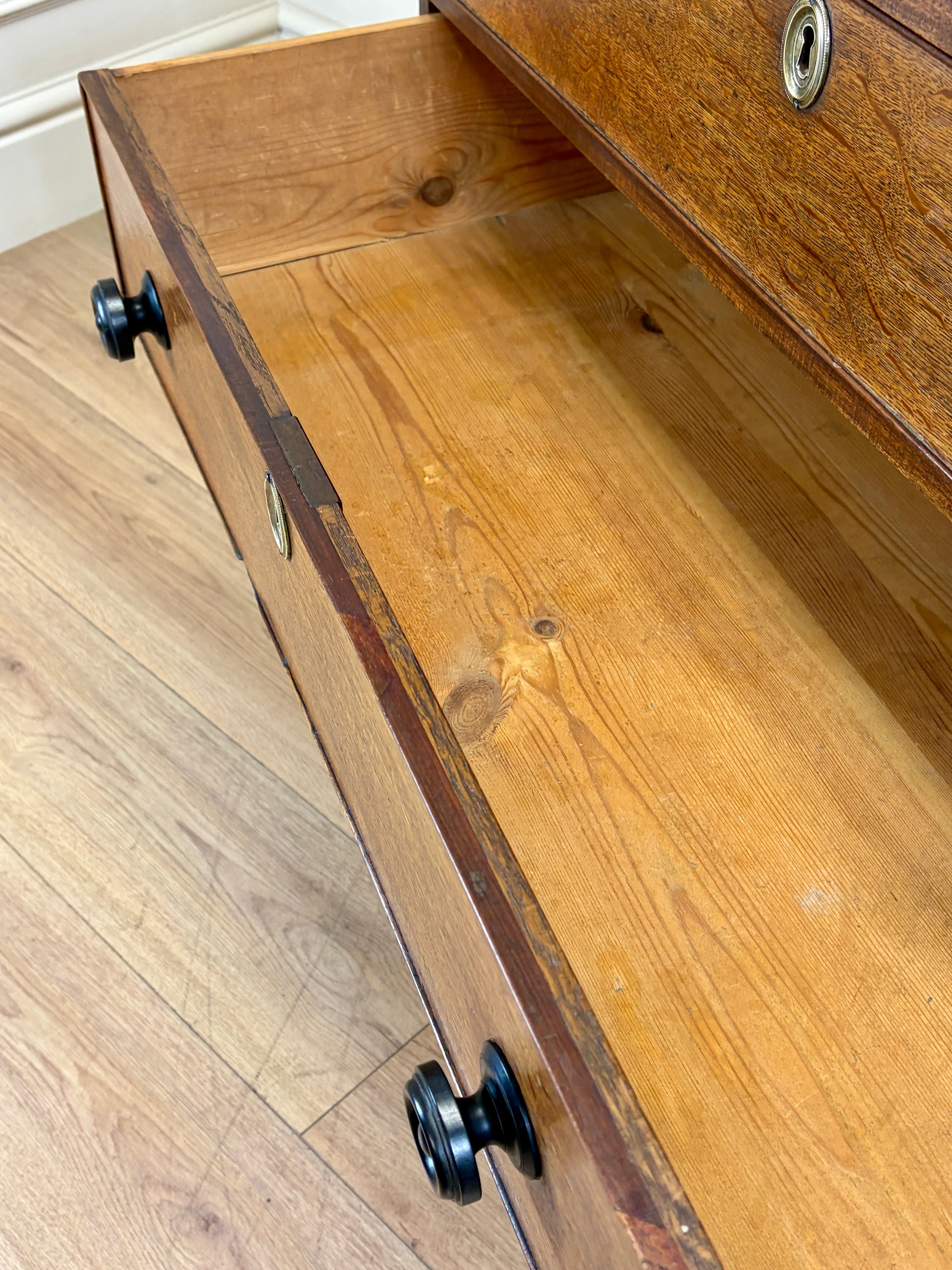 Wooden drawer with wheels on a wooden floor