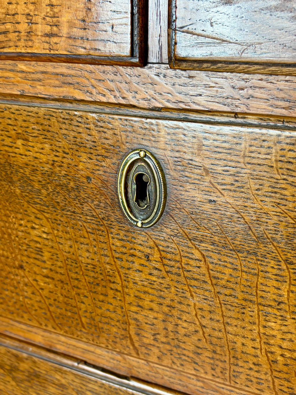 Antique light oak farmhouse chest of drawers with brass handles and patina