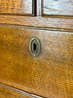 Antique light oak farmhouse chest of drawers with brass handles and patina