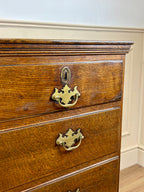 Antique light oak farmhouse chest of drawers with brass handles and patina