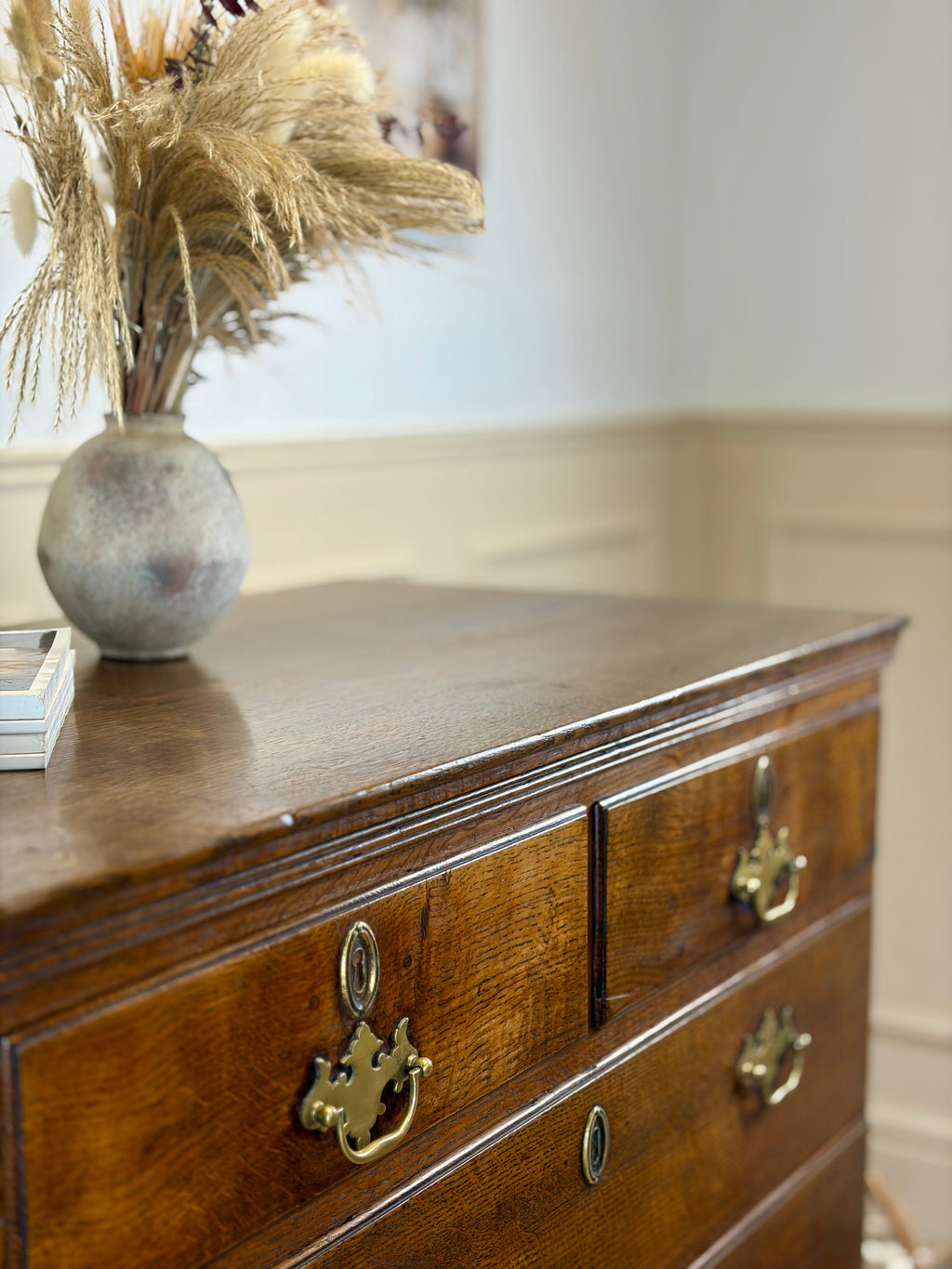 Antique light oak farmhouse chest of drawers with brass handles and patina